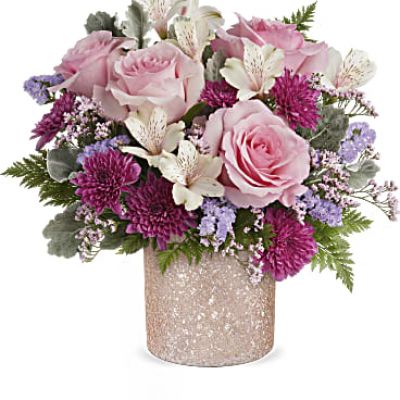 Add a touch of sparkle to Mom's day with Teleflora's Blooming Brilliant cylinder, boasting a crushed glass texture and a soft ballerina pink hue, perfect for showcasing a dreamy Mother's Day bouquet.