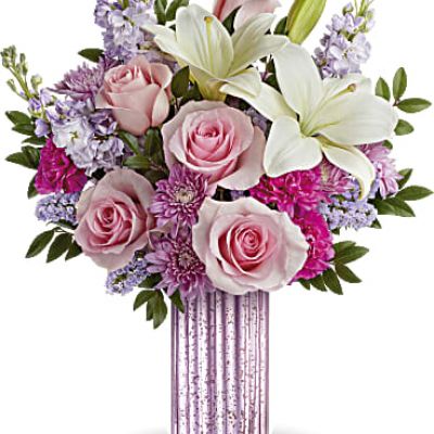 Sparkle up her Mother's Day with Teleflora's Sparkling Delight Bouquet, featuring a breathtaking bouquet of roses, lilies, and lavender accents elegantly presented in a sculpted glass vase with a lavender mercury-inspired finish..