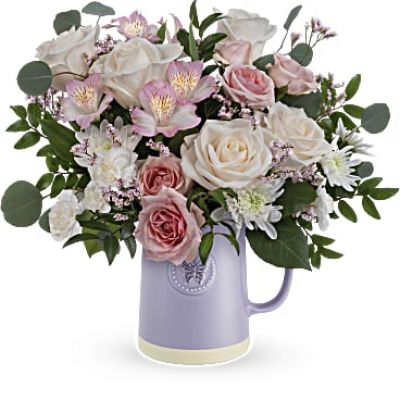 Gift Mom timeless elegance with our Teleflora's Sweetest Flutter pitcher. This food-safe ceramic pitcher is adorned with an embossed butterfly and a soothing lavender finish, making it the perfect complement to a vibrant Mother's Day bouquet.