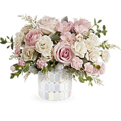 Illuminate love with Teleflora's Alluring Mosaic cylinder, embracing soft pastel shimmer and cradling an exquisite bouquet of vibrant pink flowers, a timeless expression of artistic beauty for any occasion.