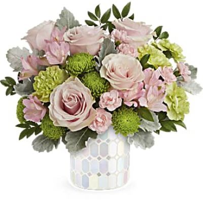Embrace timeless elegance with Teleflora's Alluring Mosaic cylinder, radiating soft pastel shimmer that beautifully complements an overflowing bouquet of pink flowers, adding a touch of artistic charm to any space.