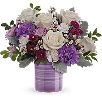 Swirling with hand-painted bands of soft lavender, this sweet ceramic keepsake vase makes a marvelous Mother's Day gift filled with a bouquet of creamy roses and purple blooms.