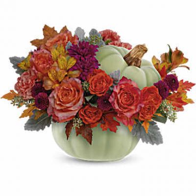 Bring autumn's charm to your table with Teleflora's Sage Harvest Bouquet, a delightful centerpiece adorned with rustic elegance. Nestled in a timeless hand-painted ceramic pumpkin, its exquisite details and warm, earthy hues create a captivating focal point.