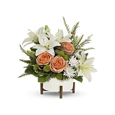 Unique in every way, this striking bouquet of peach roses and white lilies is artfully presented in a mid-mod ceramic planter with sculptural wood base.