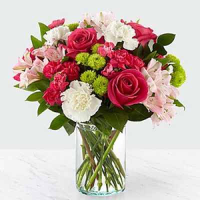 The true beauty of this bouquet is within the sweet colors of the flowers. An array of hot pink roses, pale pink alstroemeria and more are set in a glass cylinder vase, making a wonderful gift to light up the face of its recipient.