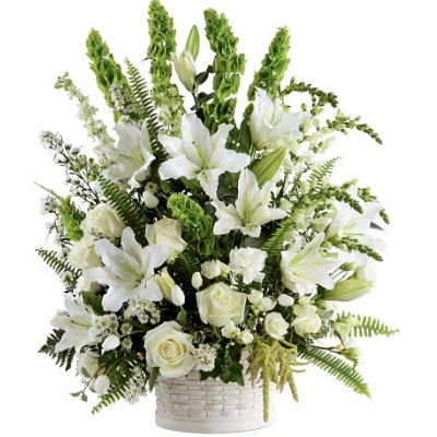 The FTD® In Our Thoughts™ Arrangement is a symbol of pure peace and caring kindness. White roses, tulips, freesia, Oriental lilies, double lisianthus, monte casino asters, and snapdragons, are beautifully offset by bright green Bells of Ireland, ivy vines, and an assortment of lush greens to create an elegant display that conveys your deepest sympathies for their loss. Arrives in a large round whitewash basket.