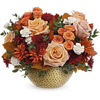 This Artisanal Gold Bouquet goes for the gold of fall flowers. This autumn bouquet is filled with lush roses and displayed in a hammered metal gold keepsake bowl that's sure to become a year-round décor favorite.